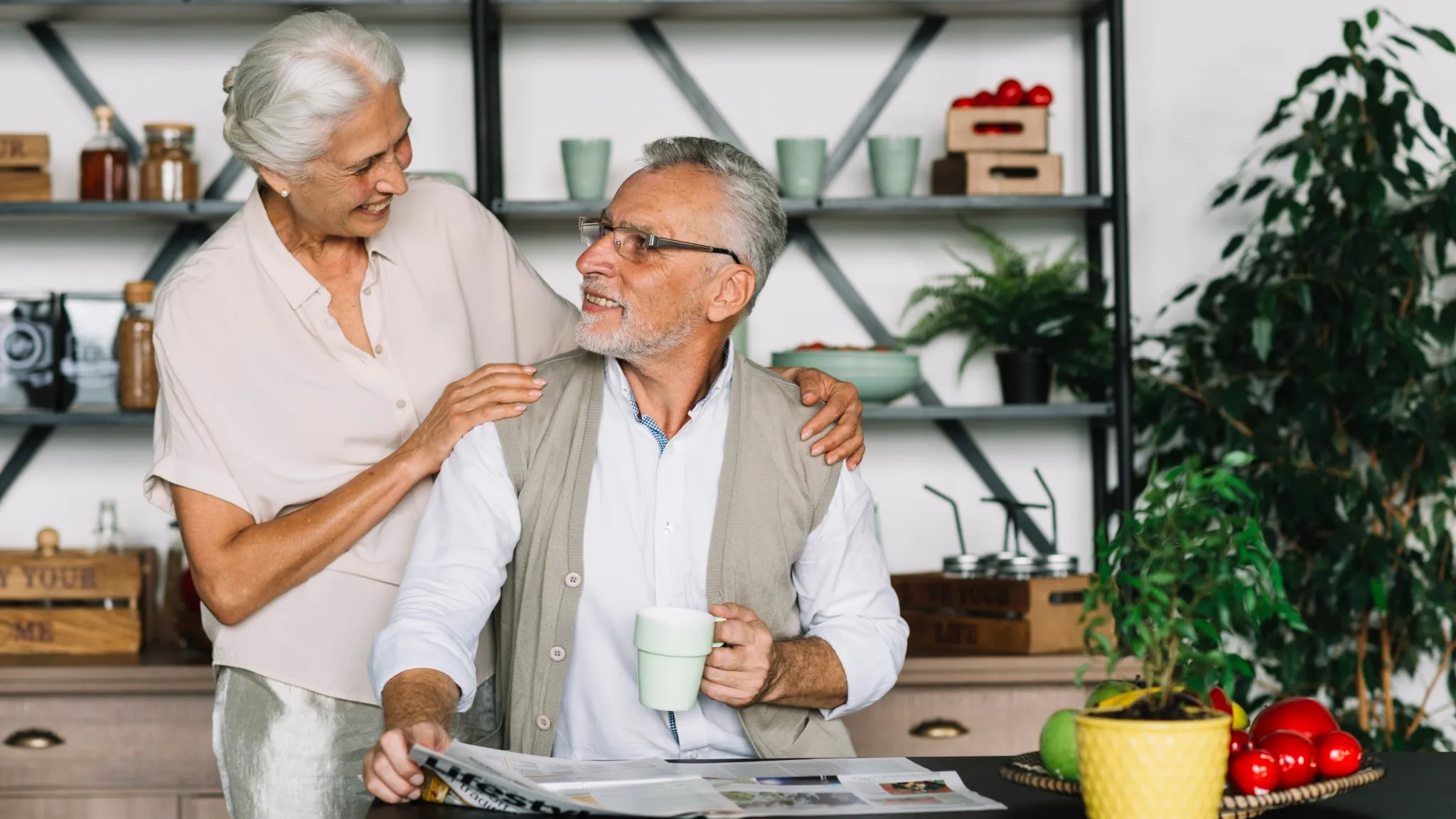 A smiling, elderly couple enjoying morning coffee in a lovely Central Developments house.