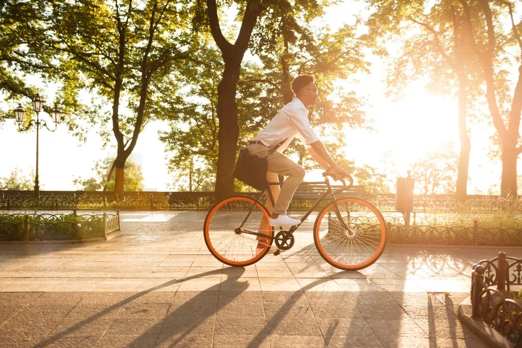 A male resident at a Central Developments property enjoying a sunny bike ride.